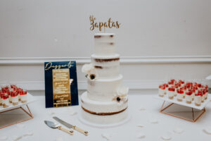 White Four-tiered Semi-Naked Wedding Cake | Personalized Gold Cake Topper | Dessert Table