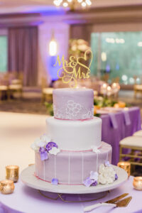 Three-tiered Round White and Purple Wedding Cake with Real Flower Accents Inspiration | Gold Mr. & Mrs. Cake Topper Ideas