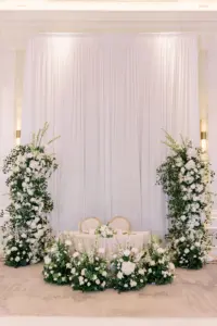 Romantic Sweetheart Table with White and Greenery Floral Arch Backdrop | Timeless Wedding Reception Ideas
