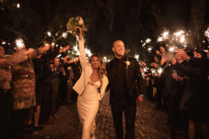 Bride and Groom Sparkler Grand Exit | White Satin Dress and Leather Jacket Wedding Reception Look Inspiration