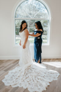 White Ivory V Neckline Lace Fit and Flare Lori Allen Couture Wedding Dress with Cathedral Length Train | Navy Mother of the Bride Off The Shoulder Dress