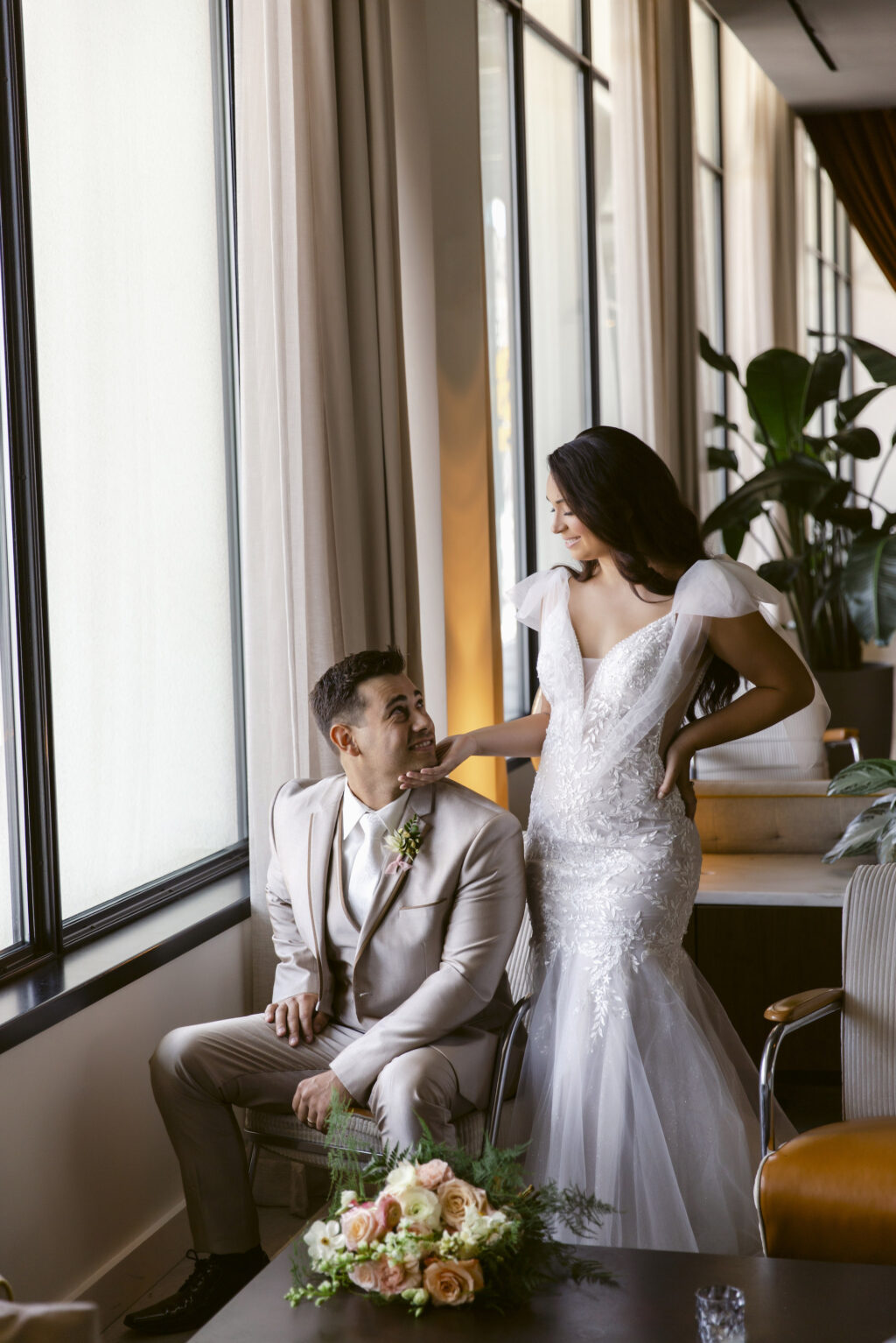 Bride and Groom Lobby Wedding Portrait | Detachable Cap Sleeves for Ivory Lace Deep V-Neckline Mermaid Wedding Dress Inspiration | Tan Three-piece Groom Suit Ideas