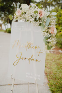 Frosted Acrylic Welcome Wedding Sign Ideas | Pink and White Roses, Baby's Breath and Eucalyptus Greenery Floral Arrangement Inspiration