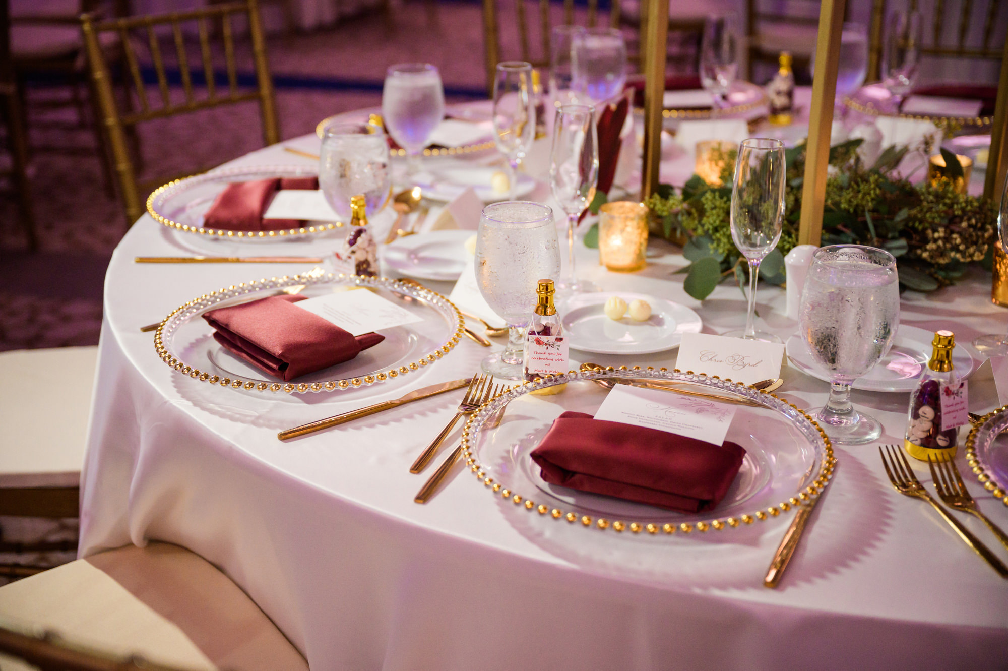 Elegant Wedding Reception Tabletop Ideas | Gold Beaded Chargers with Gold Flatware | Gold Taper Candles with Burgundy Maroon Napkin | Clearwater Wedding Rentals Gabro Event Services