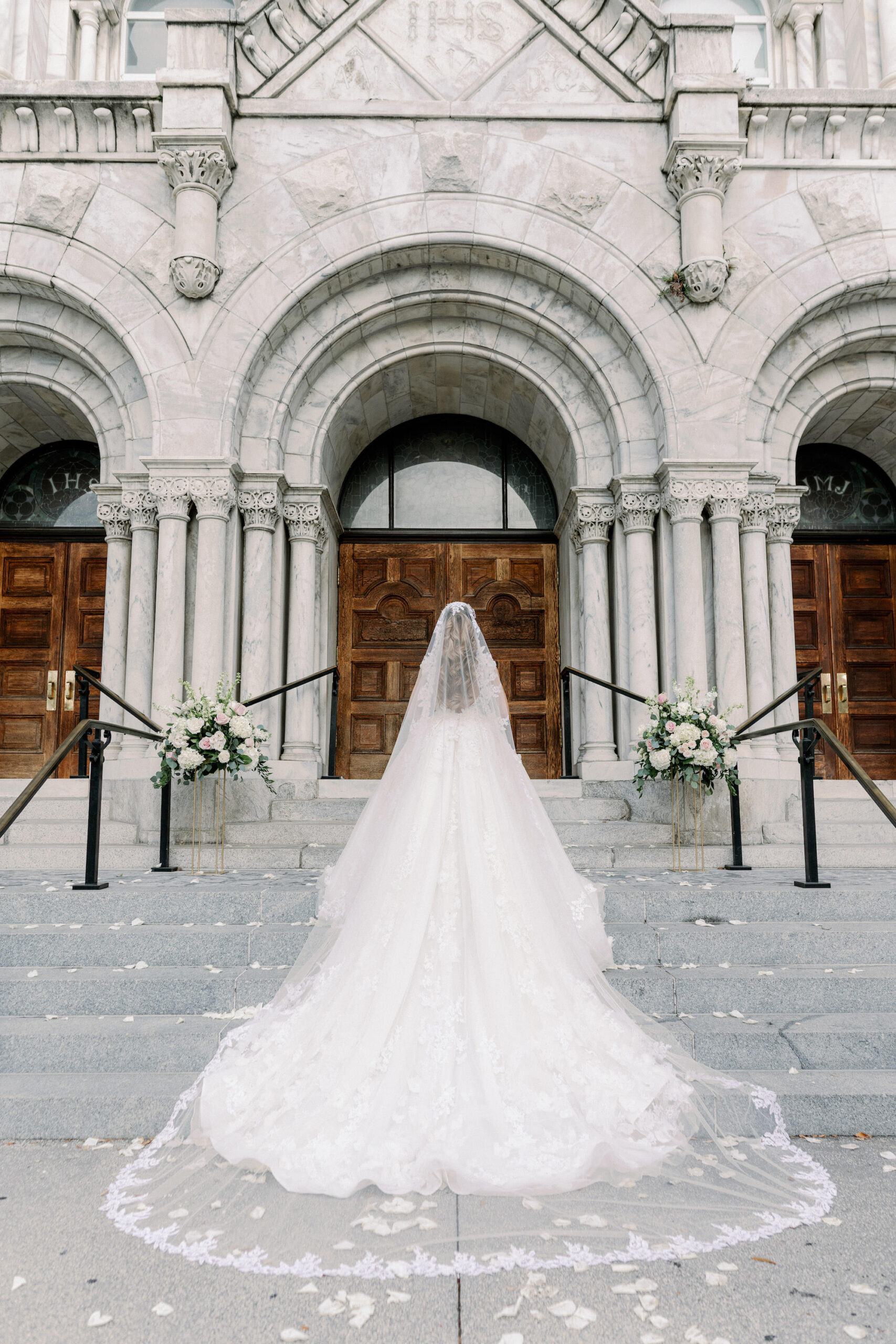 Bride Walking into Sacred Heart Catholic Church Wedding Portrait | Cathedral Length Ball Gown and Veil | Tampa Bay Wedding Photographer Dewitt for Love Photography