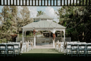 Outdoor Wedding Ceremony with White Gazebo and White Folding Chairs | Sarasota Florist Beneva Weddings