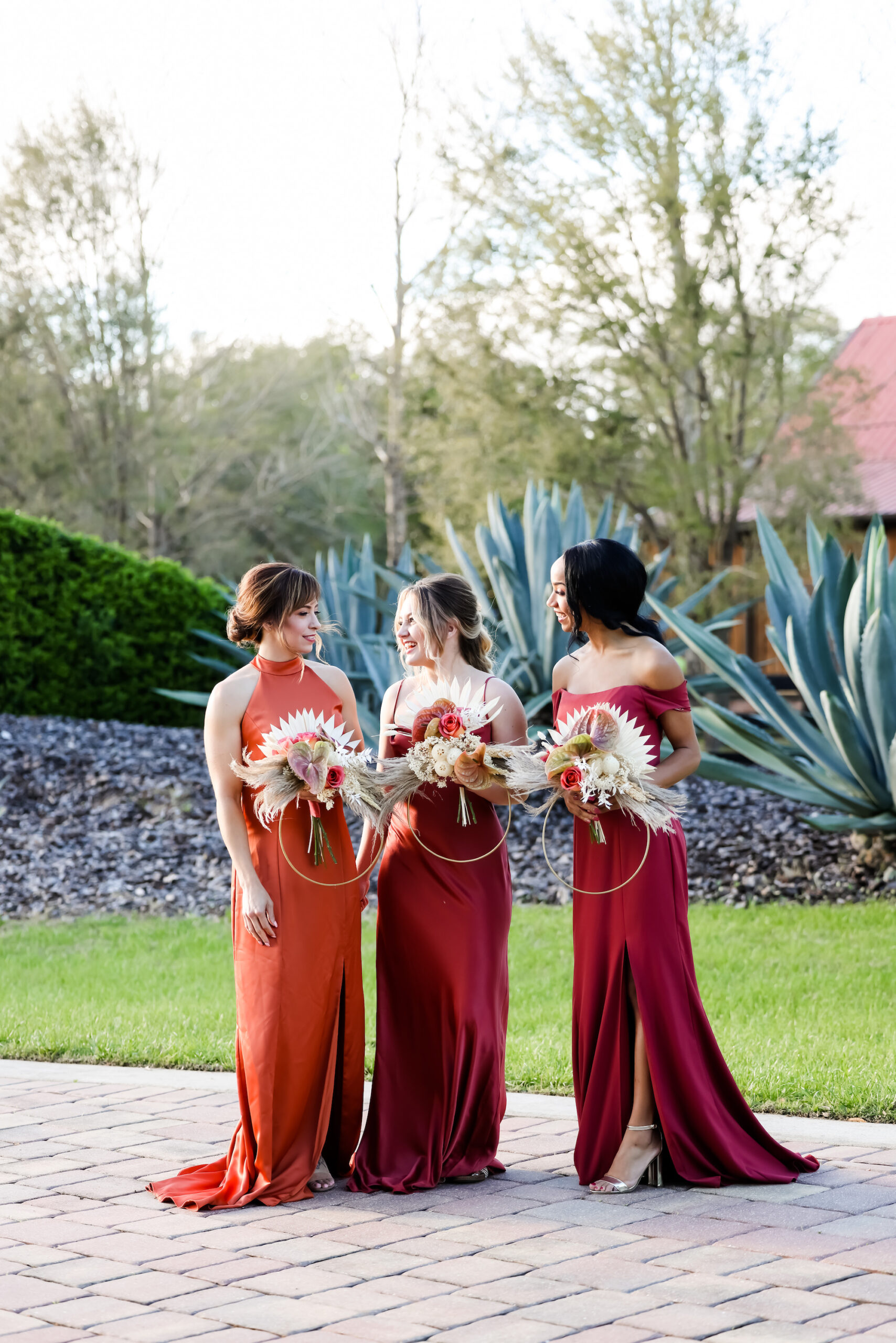 Bridesmaids in Fall Reds and Orange Mix and Match Floor Length Dresses and Unique Circle Boho Wedding Bouquets | Bella Bridesmaids Tampa