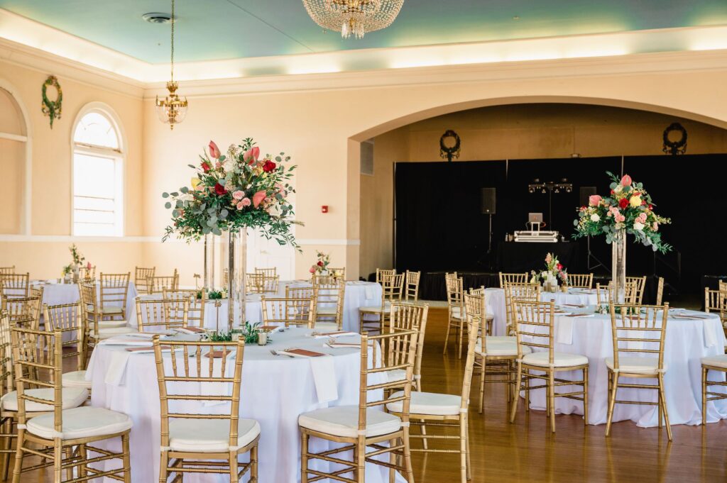Gold Chiavari Chairs with Tall Eucalyptus, Ruscus, Pink Anthurium, White and Maroon Roses Centerpiece Inspiration | White Linen | Tampa Bay Rentals A Chair Affair | Kate Ryan Event Rentals | Florist Save the Date Florida