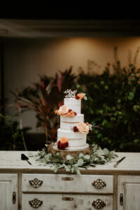 Three Tier Rustic Semi Naked Round Wedding Cake with Rose Floral Detail and Greenery