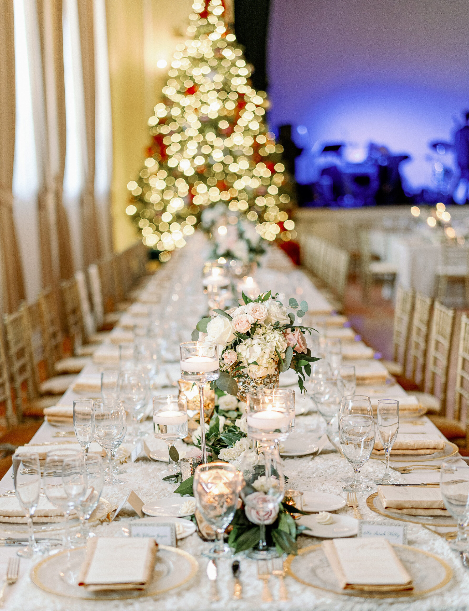 Elegant Eucalyptus Greenery Centerpieces with Gold Rimmed Chargers | Christmas Tree Wedding Decor Inspiration | Kate Ryan Event Rentals | Over The Top Rental Linens