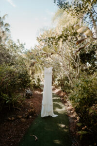 Cap Sleeve Lace Wedding Dress Hanging From Tree Wedding Portrait | Sarasota Wedding Dress Shop Truly Forever Bridal
