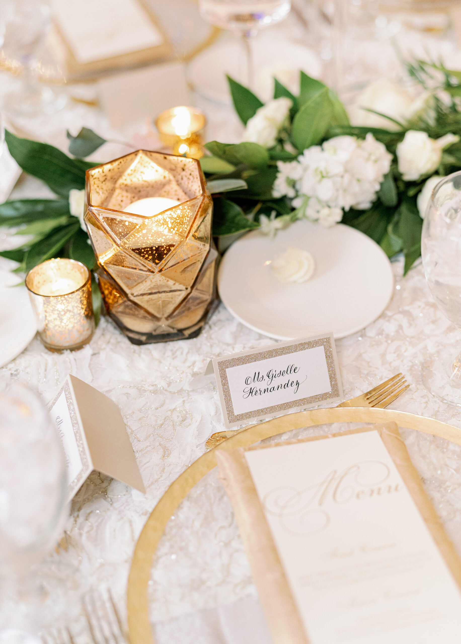Lace Table Linen with Gold Mercury Candlelit Wedding Reception Table Decor | White Hydrangea and Ruscus Greenery Centerpiece Ideas | Gold Flatware and Chargers | Tampa Bay Rentals A Chair Affair | Kate Ryan Event Rentals | Over The Top Rental Linens