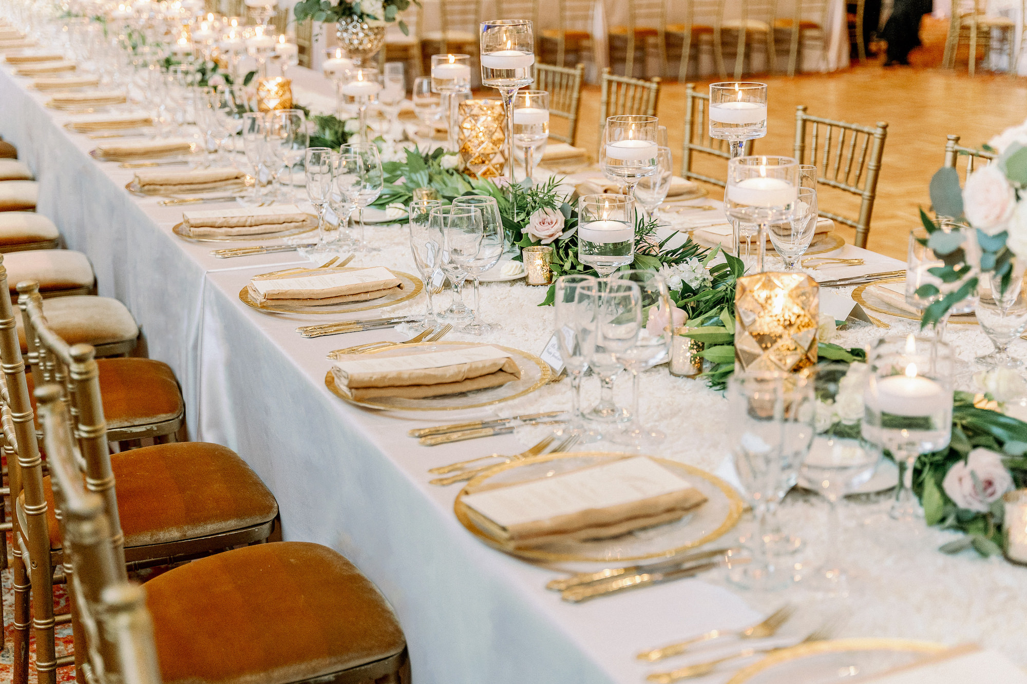 Long Feasting Table with Gold Chargers and Flatware | Timeless Gold Christmas Wedding Inspiration | Ruscus Greenery Table Runner | Tampa Bay Rentals A Chair Affair | Kate Ryan Event Rentals