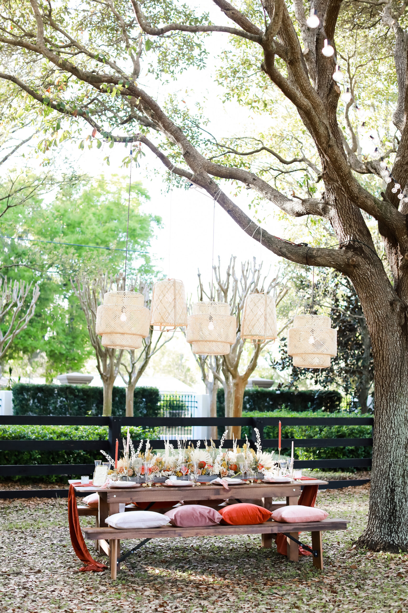 Boho Styled Wicker Lanterns Outdoor Wedding Decor Inspiration Boho Picnic with and Fall Reception Tablescape with Wooden Farm Table and Benches Centerpiece Inspiration | Tampa Bay Rentals Gabro Event Services