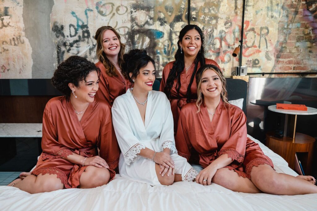 Bride and Bridesmaids Getting Ready in White and Rust Burt Orange Wedding Robes