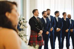 Groom's Reaction to Bride Walking Down Wedding Aisle | Navy Groomsmen Suits with Sky Blue Ties Inspiration