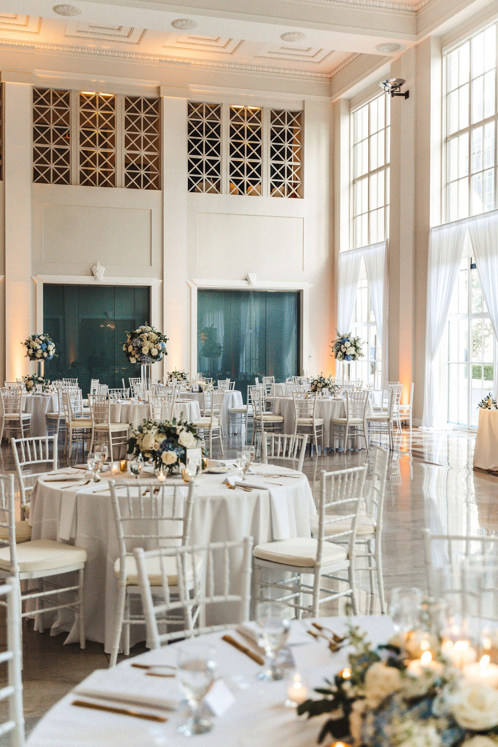 White Chiavari Chairs and Linen Wedding Reception Ideas | Open Concept with Tall Ceilings and Large Windows | Historic Tampa Bay Venue The Vault