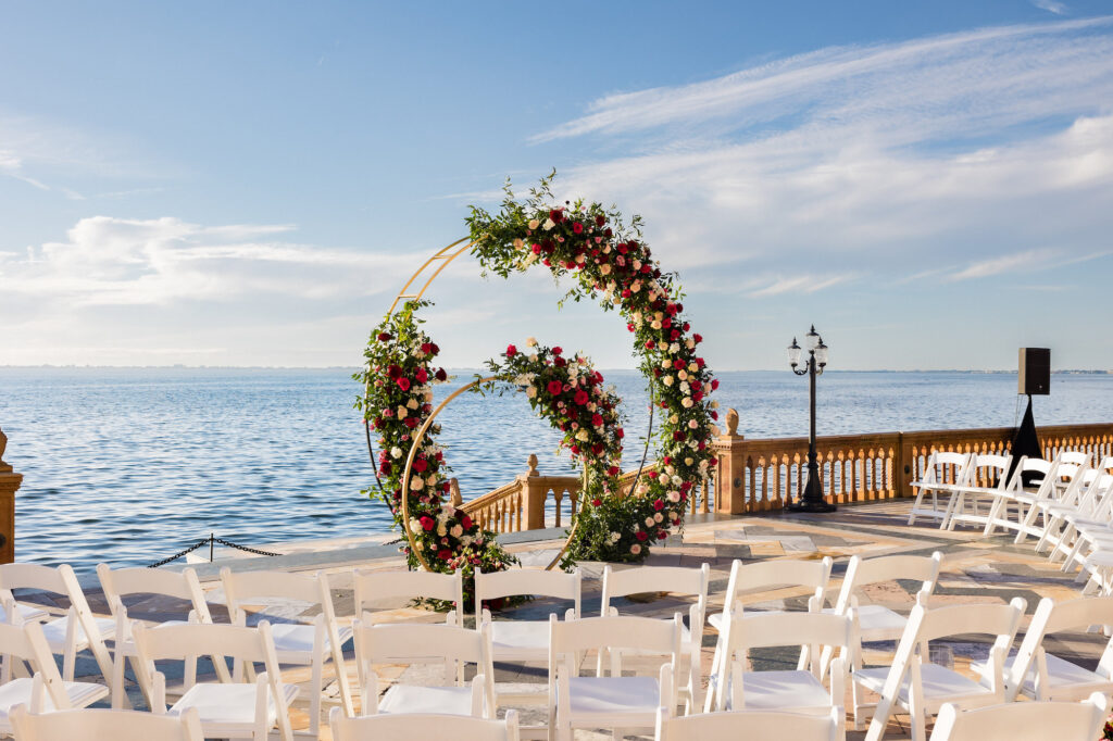Gold Round Circular Hoop Arch with Red, Burgundy, Pink Roses and Ruscus Greenery | Sarasota Waterfront Wedding Ceremony Venue The Ringling Museum | Florist FH Events