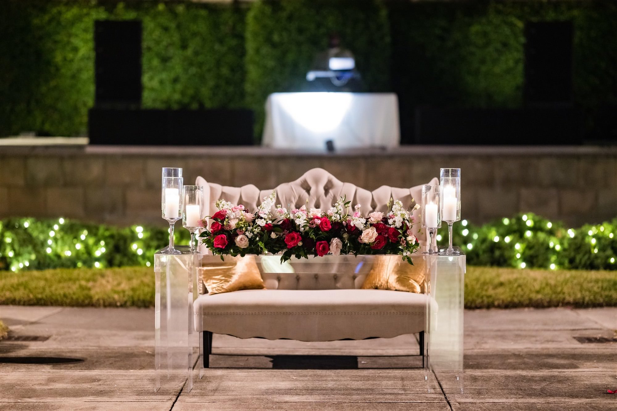 Modern Sweetheart Table Ideas | Glass Pillar Candle Holder | Pink, White, and Burgundy Rose Table Flower Arrangements with Tufted Settee Loveseat | Tampa Bay Wedding Florist FH Events