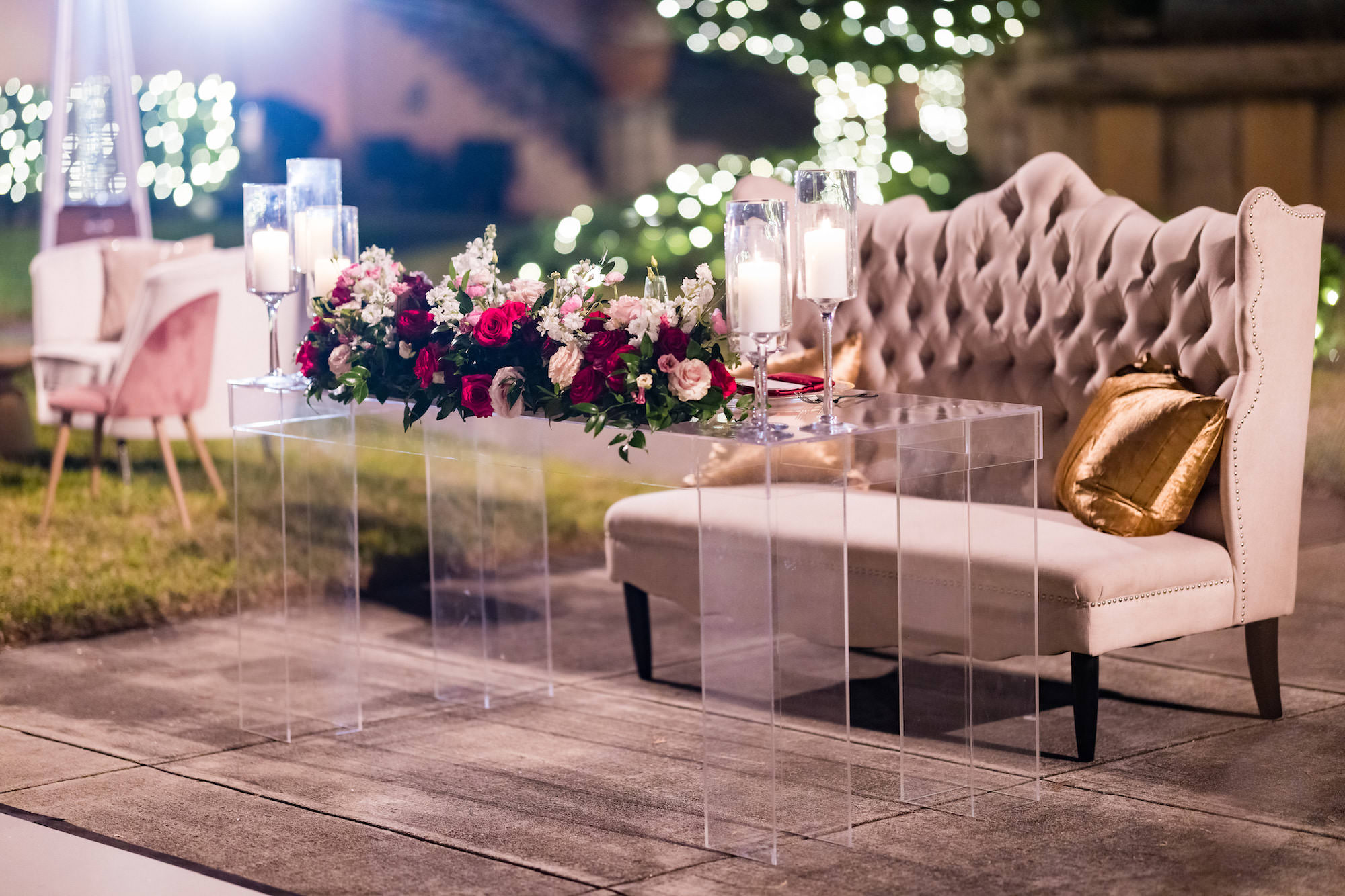Acrylic Sweetheart Table | Tufted Loveseat | Pink, White, and Burgundy Rose Table Flower Arrangements | Sarasota Wedding Florist FH Events