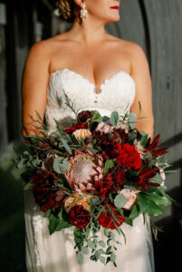Dark Moody Modern Wedding Portrait with Burgundy and Red Bouquet with King Protea Flowers | St. Petersburg Wedding Photographers Dewitt for Love Photography