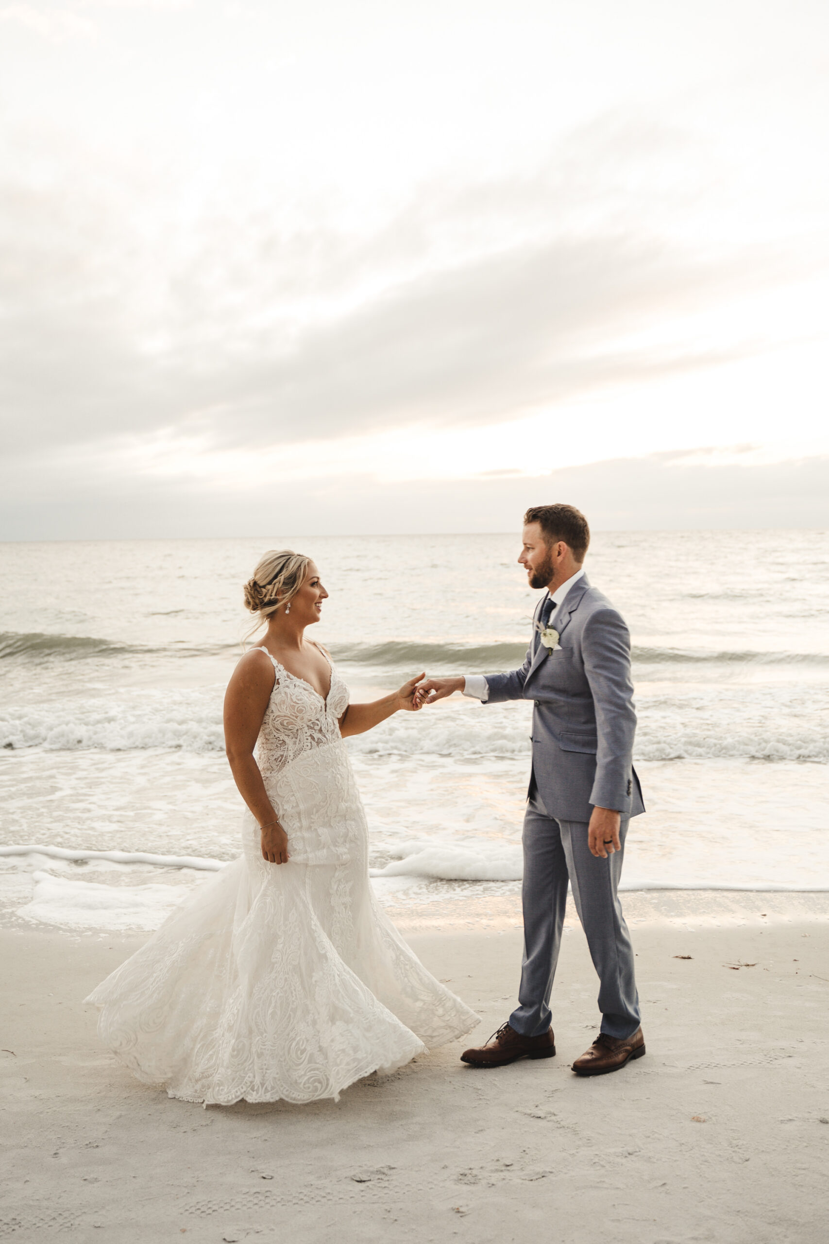 Bride and Groom Treasure Island Beach Wedding Portrait | Ivory Sheer Bodice Lace Mermaid Fit and Flare Wedding Gown Ideas | Tampa Bay Dress Boutique Truly Forever Bridal | Treasure Island Photographer Videographer J&S Media