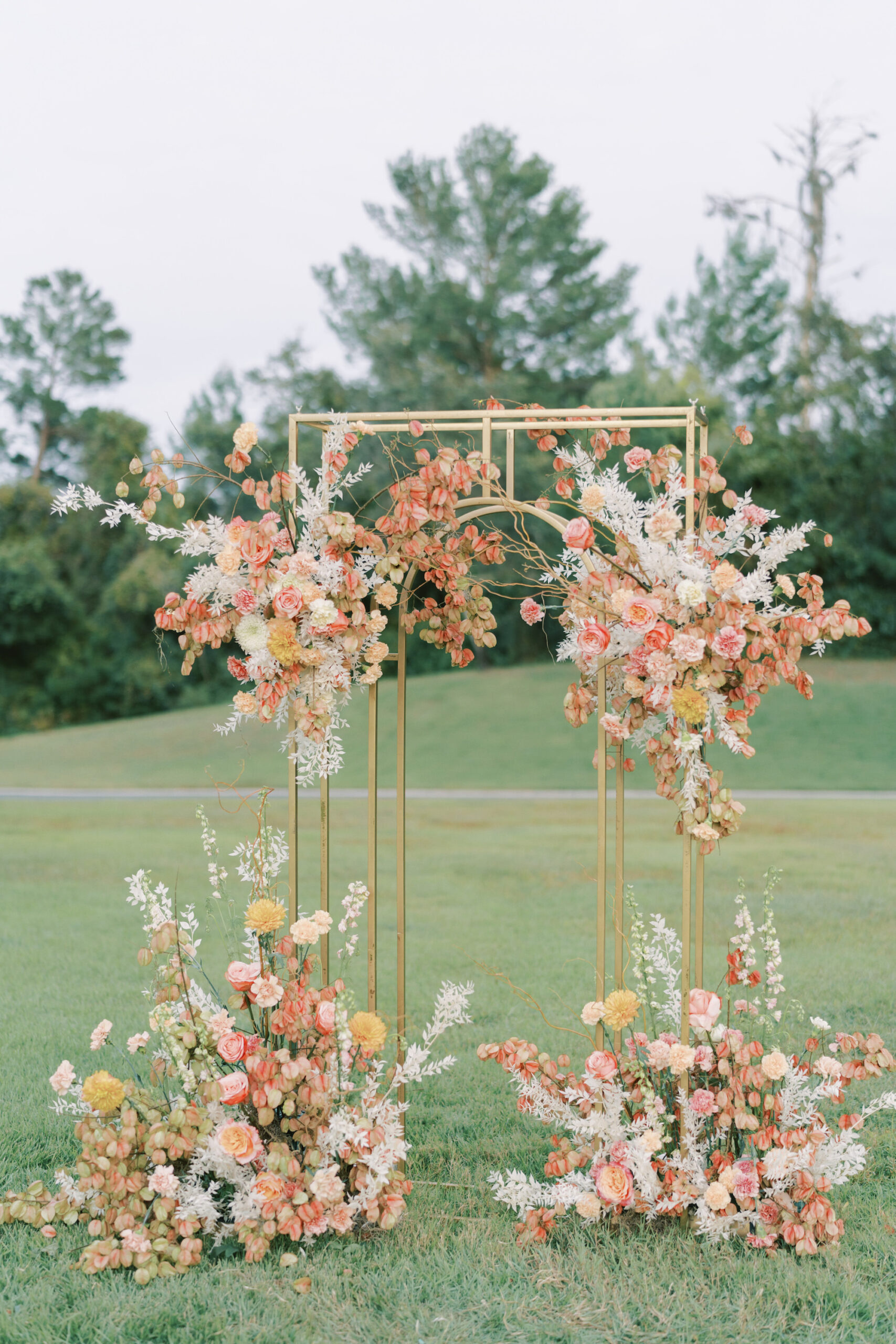 Gold Wedding Ceremony Arch with White, Pink, Peach, and Yellow Flower Arrangement Ideas | Spring Wedding Inspiration