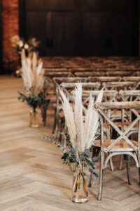Boho Ceremony Aisle Decor Inspiration | Pampas Grass, Eucalyptus Greenery | Crossback Wooden Wedding Chair Seating Ideas