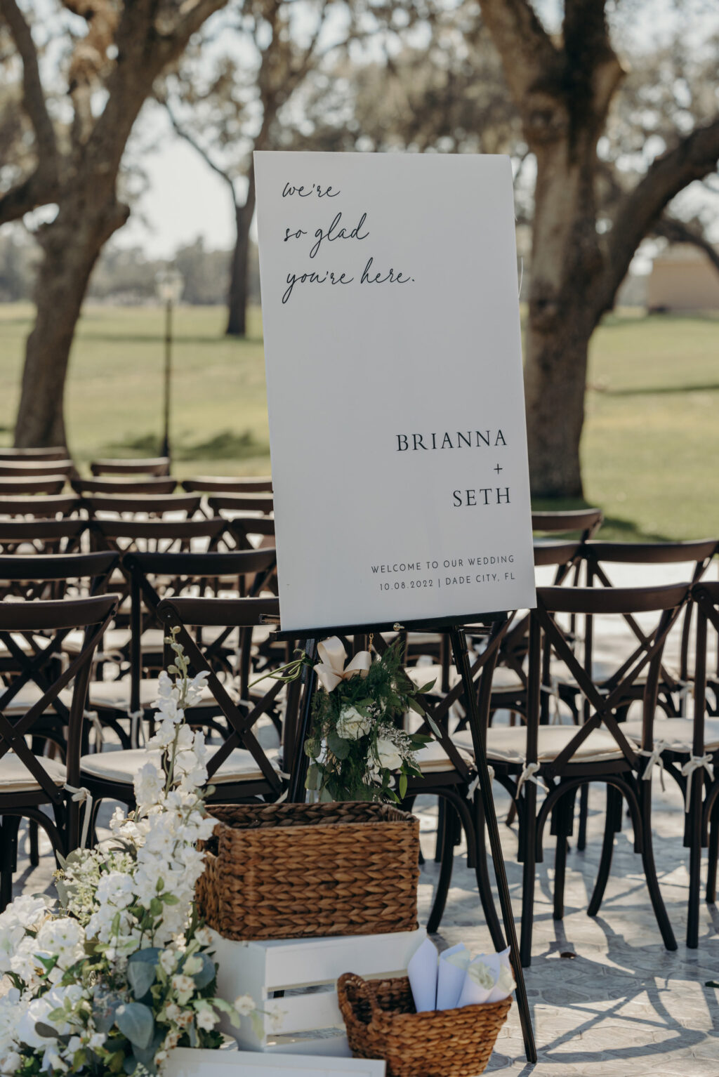 White and Black Modern Classic Welcome Wedding Sign at Outdoor Wedding Ceremony with Crossback Black Chairs Inspiration