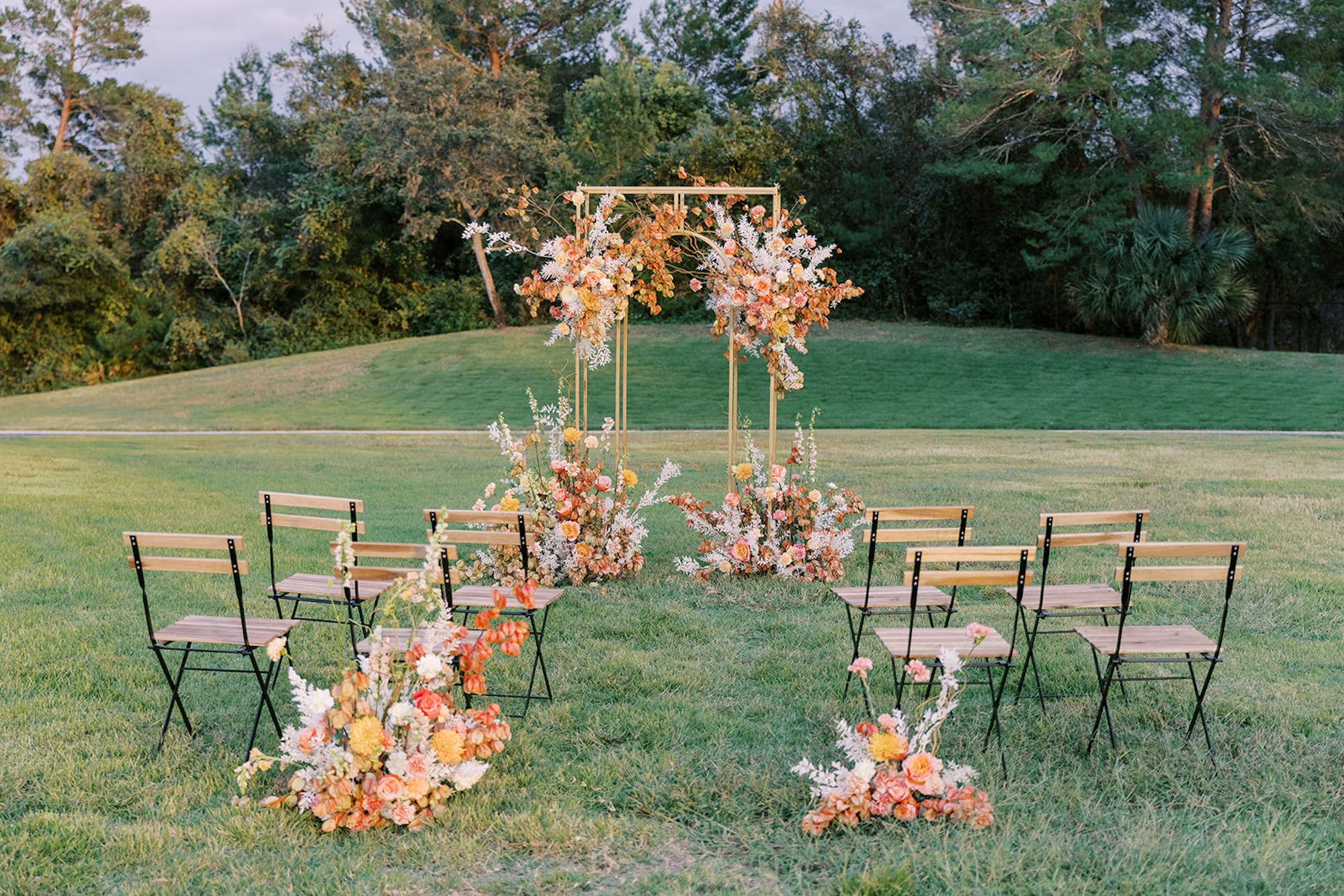 Gold Wedding Ceremony Arch with White, Pink, Peach, and Yellow Flower Arrangement Ideas | Spring Wedding Inspiration | Venue Whitehurst Gallery