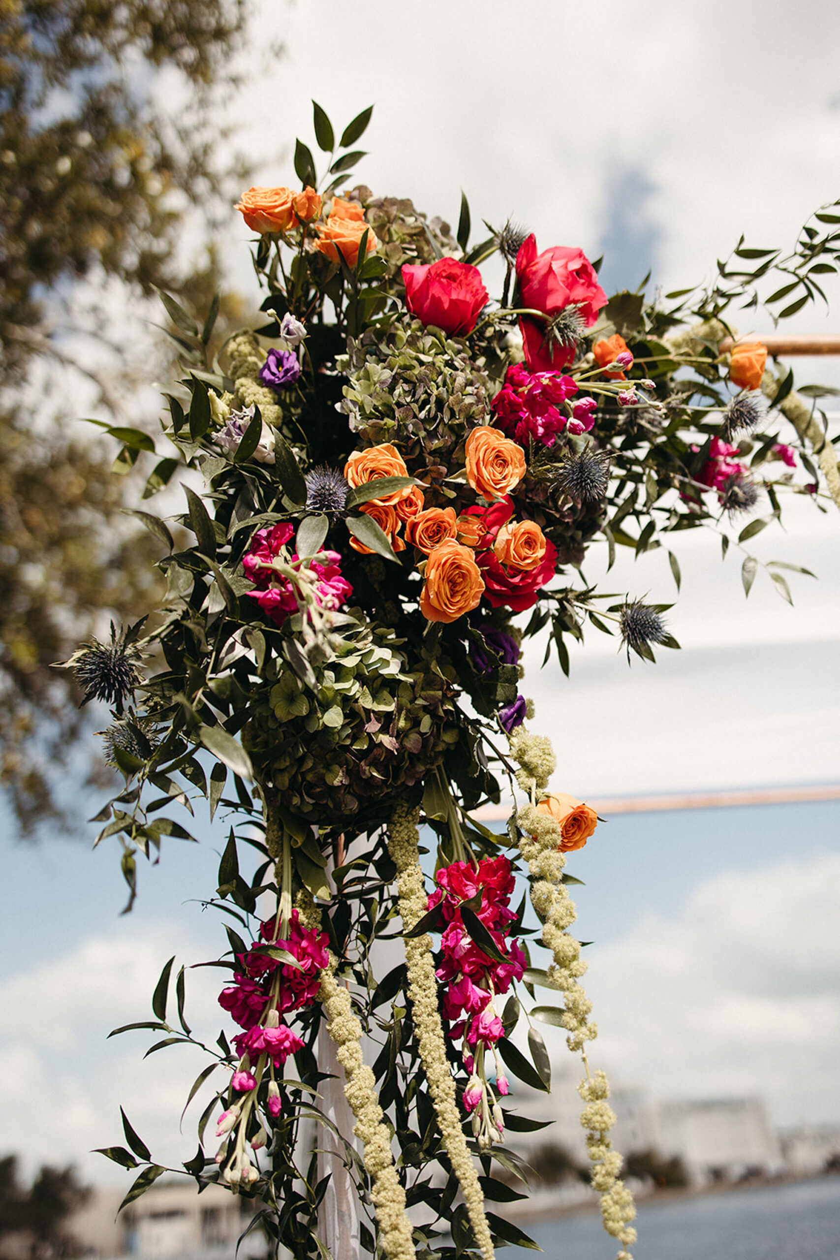 Vibrant Roses, Thistle, Cascading Chuppah Floral Arrangement Inspiration | Jewish Wedding Traditions