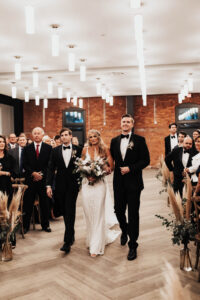 Bride and Brothers Walking Down Wedding Aisle