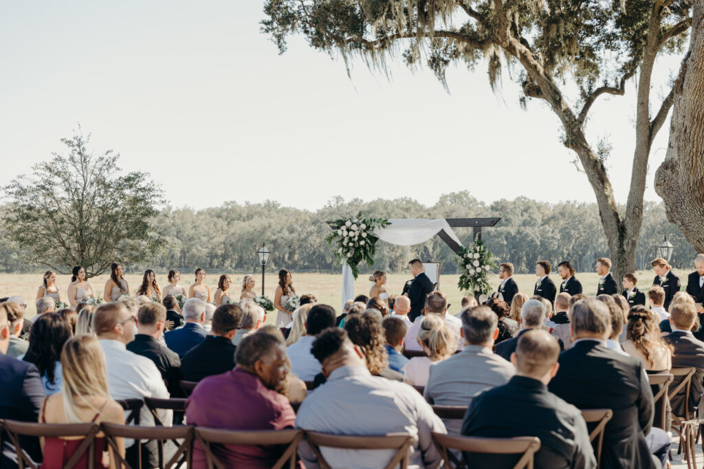 Bride and Groom Exchange Vows at Outdoor Rustic Wedding Ceremony | Tampa Bay Wedding Venue Simpson Lakes