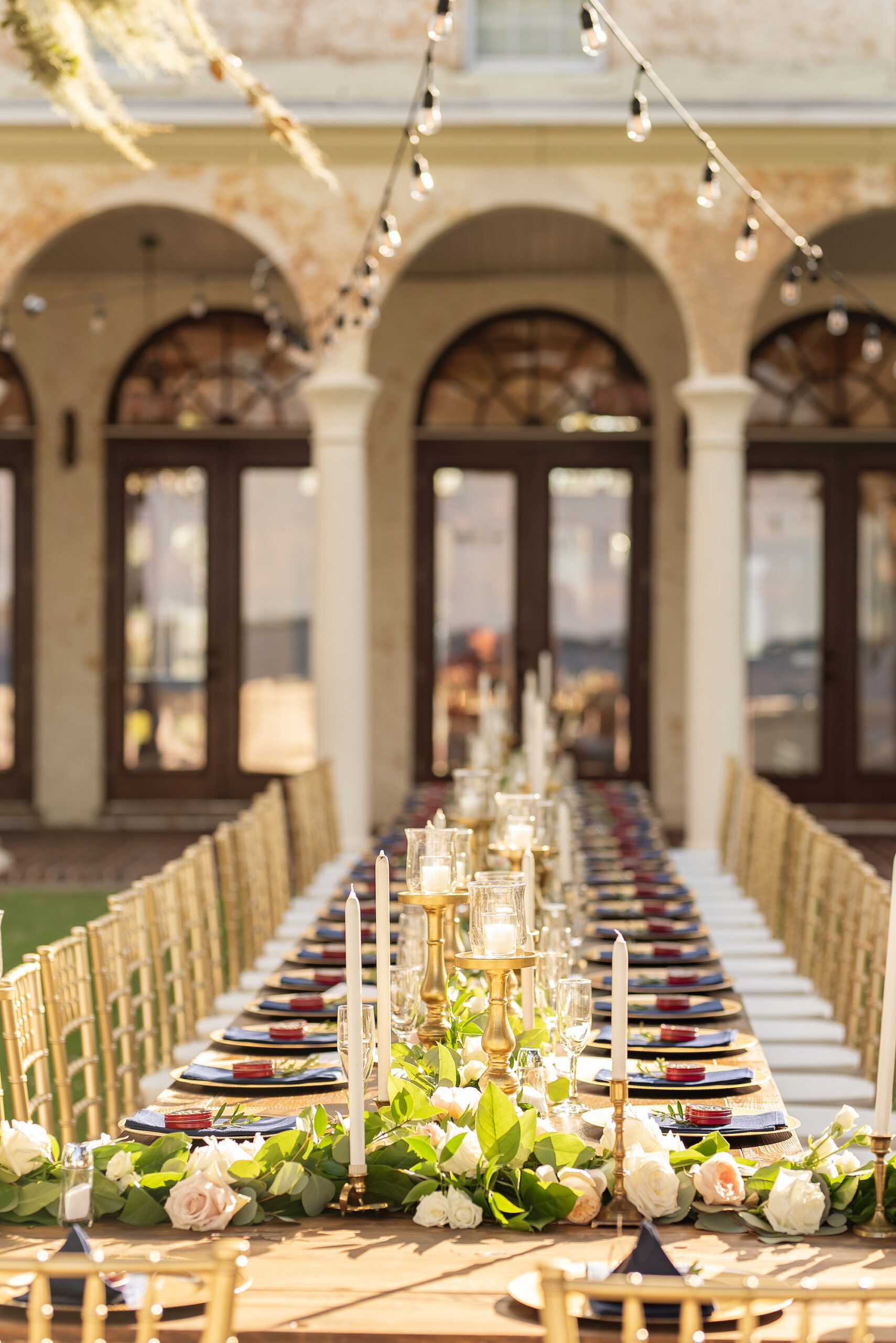 Italian Inspired Tuscan Wedding Reception Decor | Long Feasting Table with Gold Chiavari Chairs | Taper Candle, Votive Candle Centerpiece Inspiration