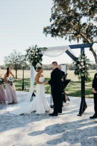 Bride and Groom Exchange Vows at Outdoor Rustic Wedding Ceremony | Tampa Wedding Venue Simpson Lakes
