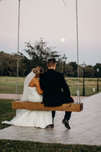 Bride and Groom on Swing at Sunset Wedding Portrait | Tampa Bay Wedding Venue Simpson Lakes