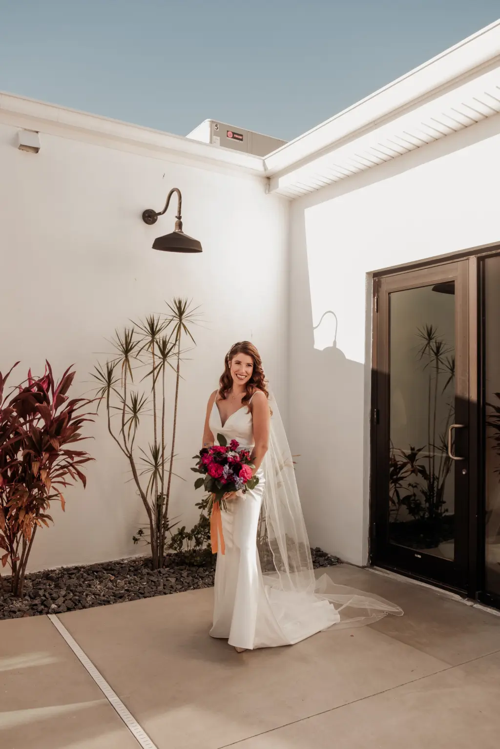 Bride in Fitted Wedding Dress and Cathedral Veil with Dark Floral Bouquet Ideas with Reds and Purples Bridal Wedding Portrait | Madeira Beach Venue The West Events