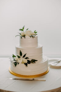 White Three-tiered Buttercream Wedding Cake with Live Flowers | Simple Cake Table Ideas