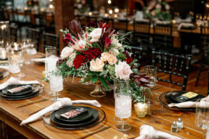 Dark Moody Modern Wedding Reception with Red Burgundy Centerpiece Inspiration and Black Chargers