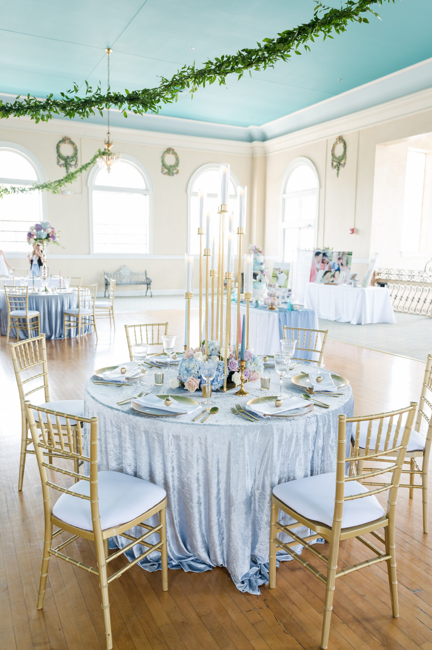 Pastel Blue Linen with Gold Chiaviari Chairs | Whimsical Spring Marie Antoinette Inspired Wedding Reception Ideas with Elegant Tall Gold Taper Candle Stand Wedding Centerpiece Inspiration