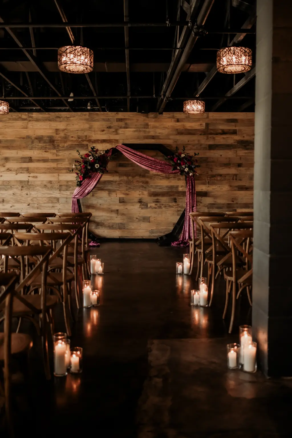 Dark and Moody Wedding Ceremony with Wooden Arch Draped in Purple Velvet, Crossback Chairs, and Pillar Candle Aisle Decor Ideas | Madeira Beach Venue The West Events