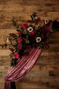 Dark and Moody Wedding Florals for Wooden Ceremony Arch and Purple Velvet Draping Ideas