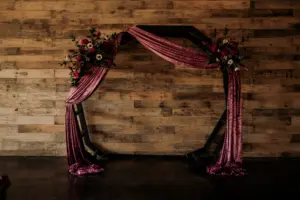 Dark and Moody Wedding Florals for Wooden Ceremony Arch and Purple Velvet Draping Ideas