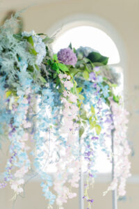 Spring Garden Inspired Pink and Blue Cascading Wisteria and Purple Hydrangreas Wedding Sweetheart Table Floral Arrangement Ideas | Tampa Florist Save the Date Florida