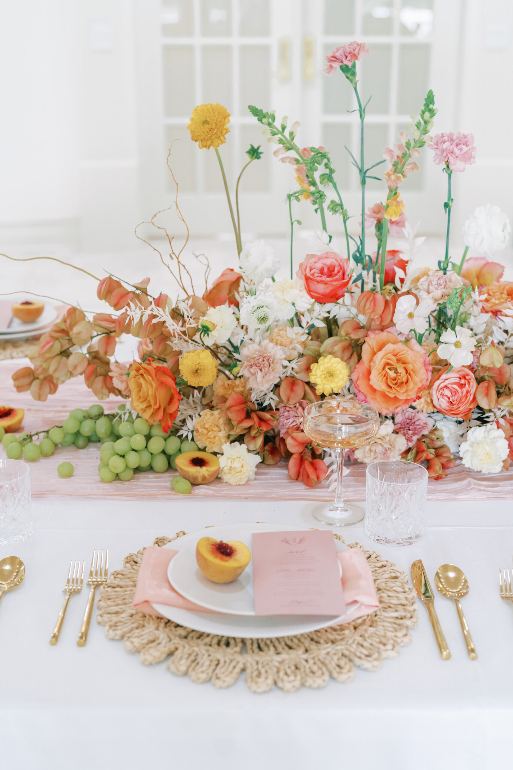 Yellow, Orange, and Pink Garden Rose Dahlia, and Wildflower Centerpiece Ideas | Gold Flatware | White Tablecloth Linen | Individual Menu Inspiration | Hyacinth Placemat | Peach Themed Wedding Inspiration | Stationer A&P Designs