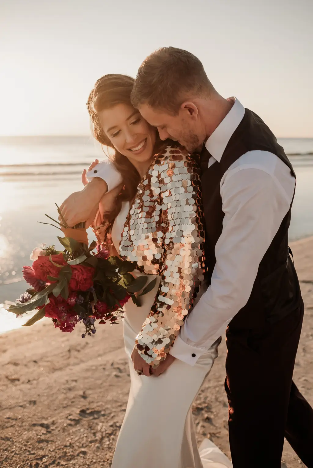 Bright in Sequin Offbeat Bridal Jacket with Groom in Intimate Bridal Portrait on the Beach