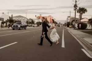 Bride and Groom Walking Across the Street Wedding Portrait