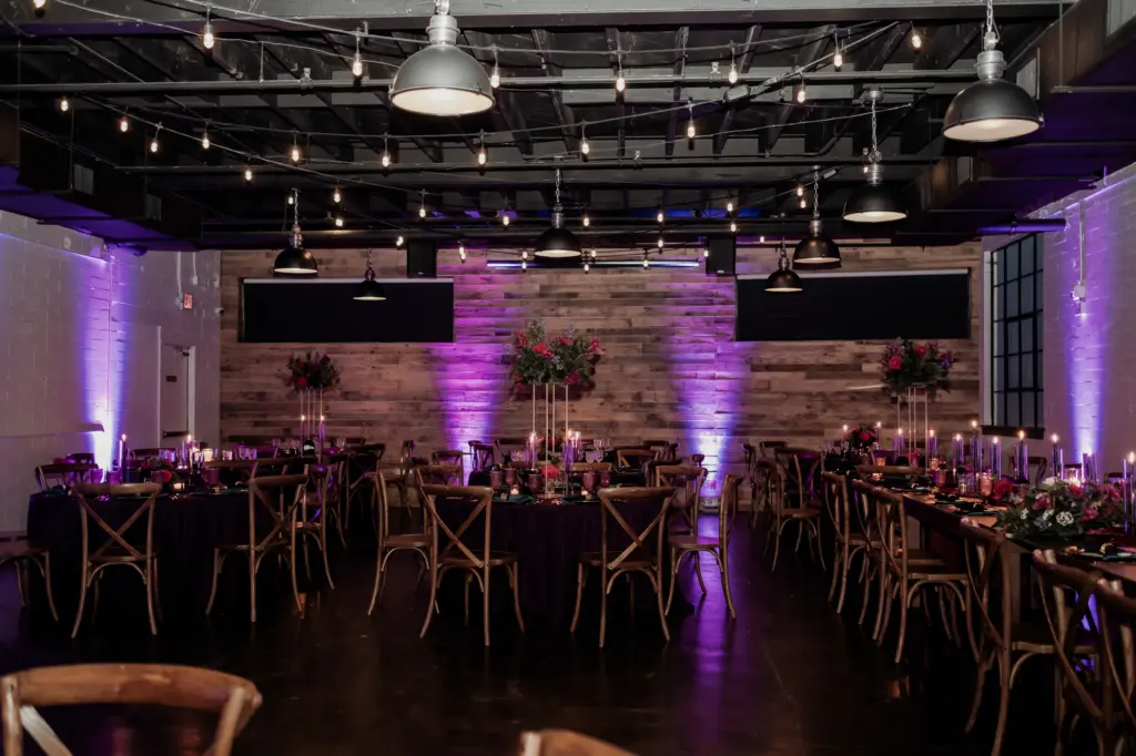 Dark and Moody Wedding Reception Ideas with Purple Mood Lighting and Wooden Crossback Chairs and Round and Feasting Tables | Madeira Beach Venue The West Events