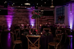 Dark and Moody Wedding Reception Ideas with Purple Uplighting, Tall Gold and Floral Centerpieces and Wooden Crossback Chairs | Madeira Beach Venue The West Events
