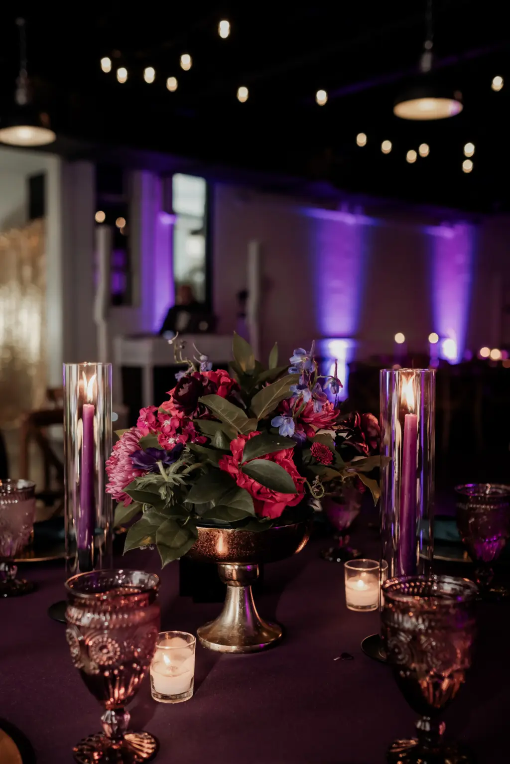 Dark and Moody Wedding Reception Centerpiece Inspiration with Black Pillar Candles and Gold Accents